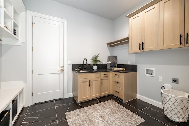 laundry area featuring hookup for a washing machine, baseboards, cabinet space, a sink, and electric dryer hookup