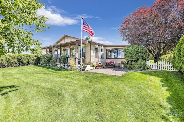 back of house with a patio area, fence, and a lawn