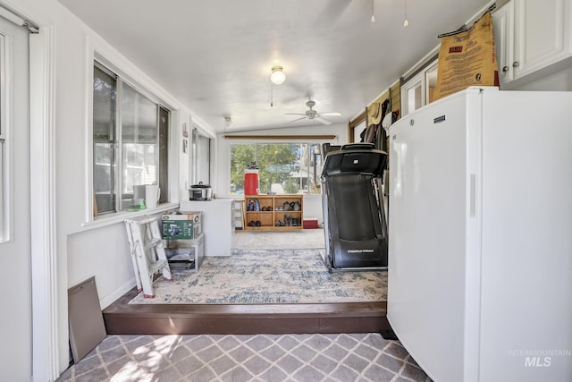 kitchen featuring white cabinetry, light countertops, a ceiling fan, and freestanding refrigerator