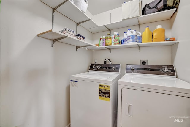 washroom with washing machine and dryer and laundry area