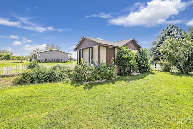 view of property exterior featuring fence and a lawn