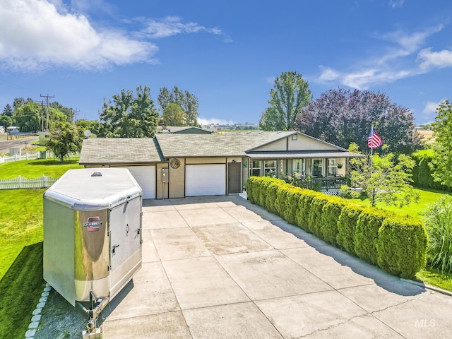 view of front of property with concrete driveway and an attached garage