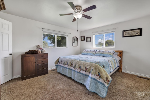 bedroom with ceiling fan, carpet flooring, visible vents, and baseboards