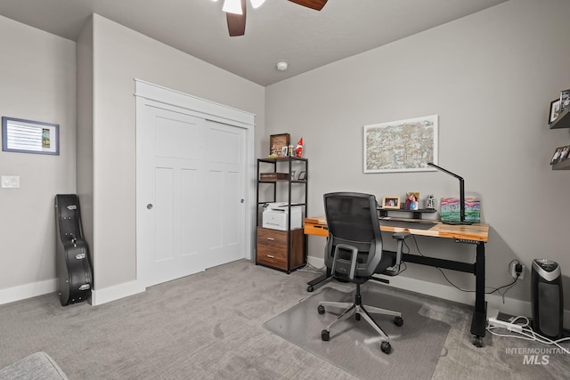 home office with carpet flooring, a ceiling fan, and baseboards
