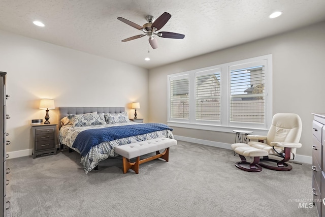 carpeted bedroom featuring baseboards and recessed lighting
