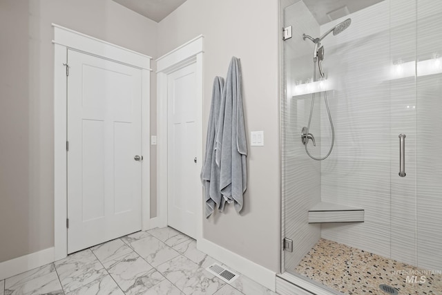 full bath with marble finish floor, baseboards, a stall shower, and visible vents