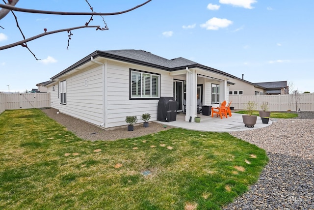 rear view of property with a patio, a fenced backyard, and a lawn