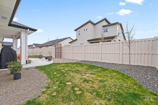 view of yard with a fenced backyard, visible vents, and a patio area