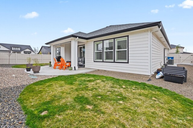 back of house with fence, central AC unit, a yard, and a patio area
