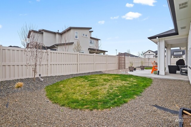 view of yard with a fenced backyard, visible vents, and a patio area