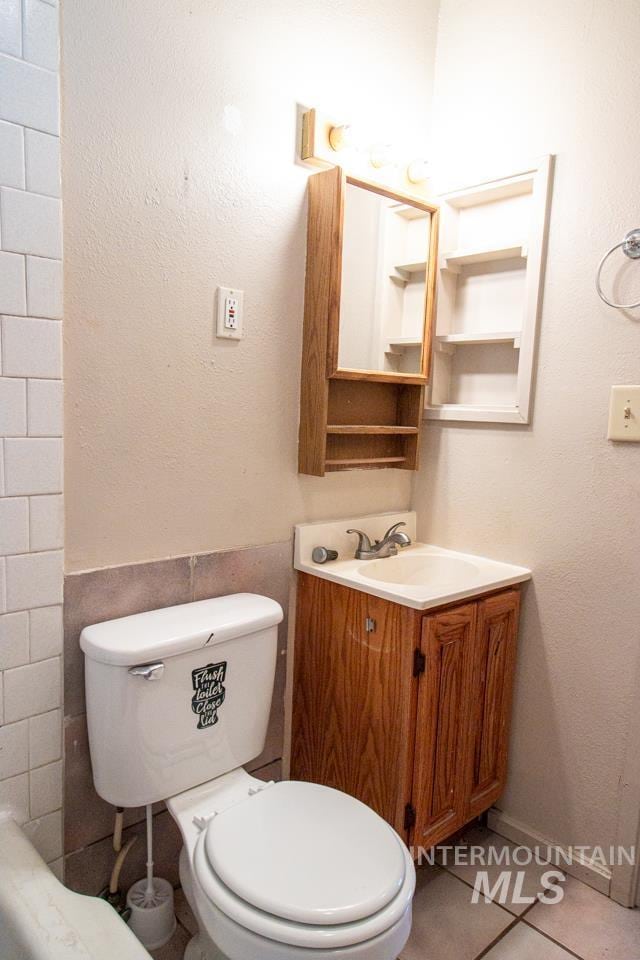 402 S Hayes, Emmett, ID 83617 - bathroom with vanity, tile patterned floors, and tile walls