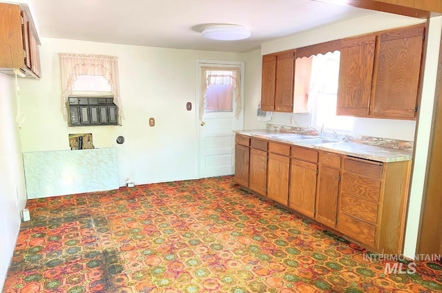 545 Madison St, Twin Falls, ID 83301 - kitchen with a sink, brown cabinetry, healthy amount of natural light, and light countertops