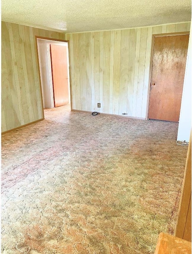 545 Madison St, Twin Falls, ID 83301 - carpeted spare room featuring a textured ceiling and wooden walls