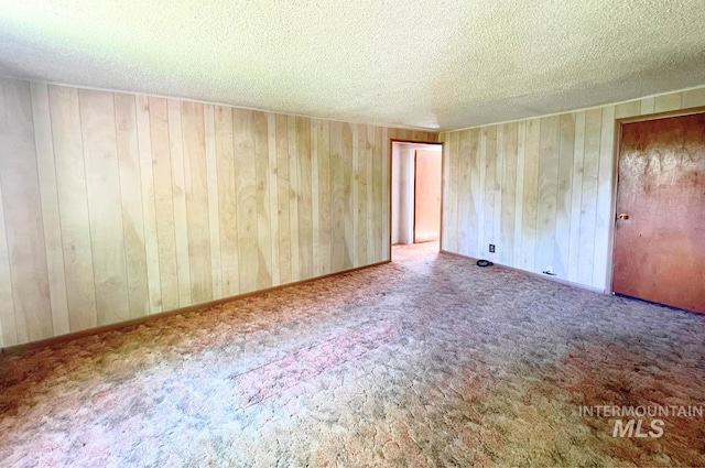 545 Madison St, Twin Falls, ID 83301 - carpeted empty room with a textured ceiling and wood walls