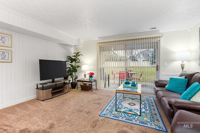 carpeted living room with ornamental molding