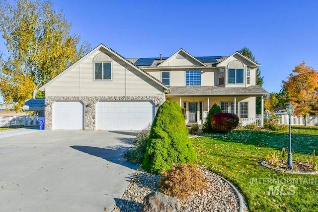 view of front property with a garage, a front yard, and a porch