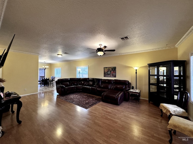 3485 N Chatterton Ave, Boise, ID 83713 - living area featuring a chandelier, crown molding, wood finished floors, a textured ceiling, and ceiling fan