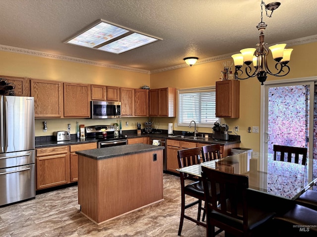 3485 N Chatterton Ave, Boise, ID 83713 - kitchen featuring appliances with stainless steel finishes, a textured ceiling, ornamental molding, a chandelier, and brown cabinets