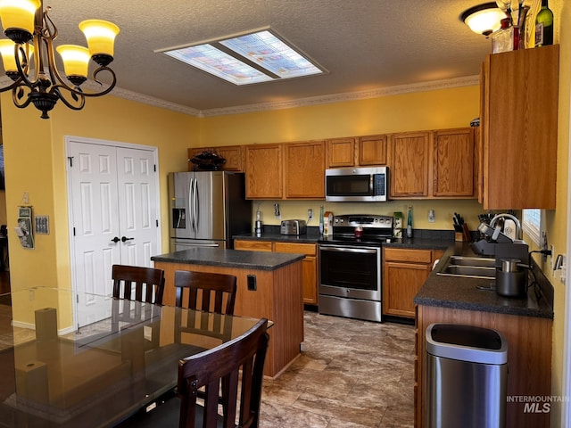 3485 N Chatterton Ave, Boise, ID 83713 - kitchen with stainless steel appliances, brown cabinets, dark countertops, a chandelier, and a textured ceiling
