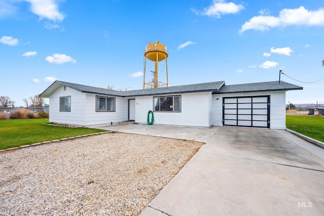 ranch-style home featuring a front lawn and a garage