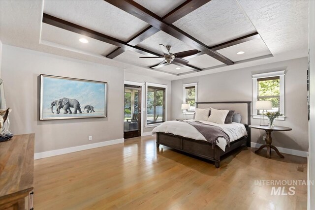 4307 W Briar Rock Ct, Eagle, ID 83616 - bedroom with baseboards, light wood-style floors, coffered ceiling, beamed ceiling, and a ceiling fan