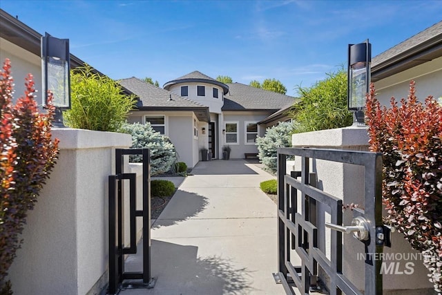 4307 W Briar Rock Ct, Eagle, ID 83616 - view of front of home featuring stucco siding, a gate, and a shingled roof