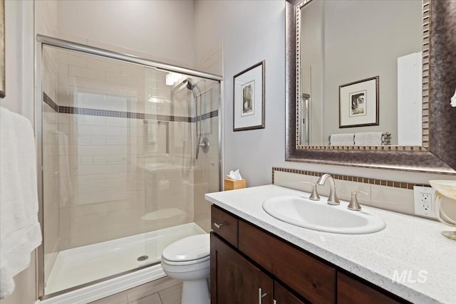 4307 W Briar Rock Ct, Eagle, ID 83616 - bathroom with toilet, a stall shower, vanity, and decorative backsplash