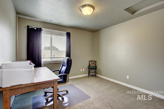 carpeted home office with visible vents, baseboards, and a textured ceiling