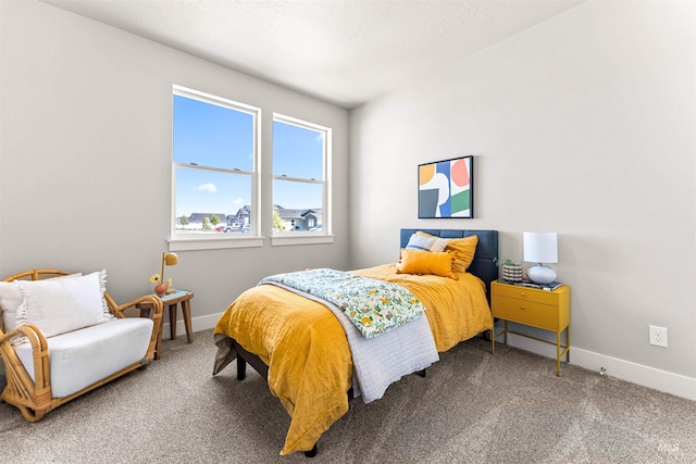 bedroom with baseboards and carpet