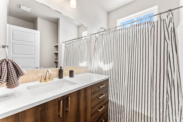 full bath with decorative backsplash, curtained shower, and vanity