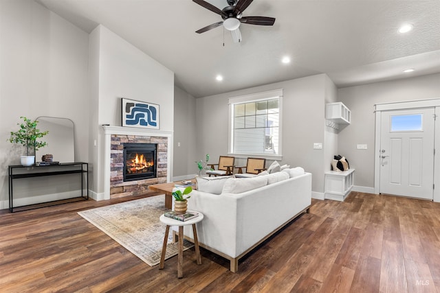 living room with vaulted ceiling, a wealth of natural light, a ceiling fan, and dark wood-type flooring