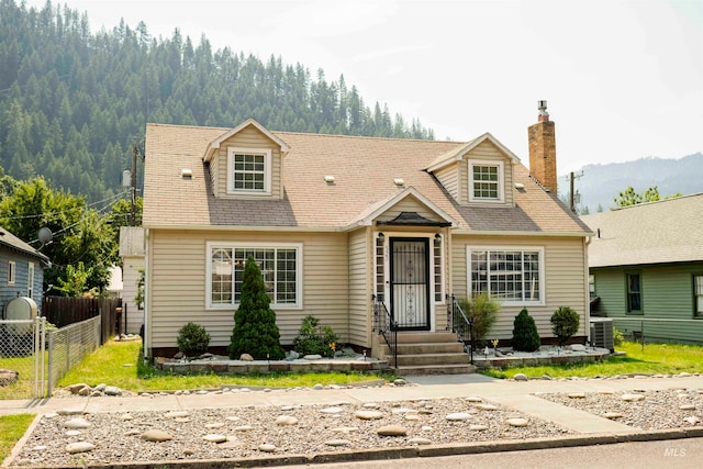 new england style home featuring cooling unit and a mountain view