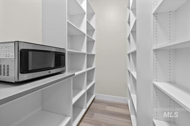 walk in closet featuring light hardwood / wood-style floors