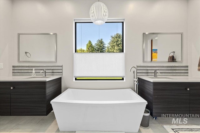 bathroom featuring vanity, a bathtub, and tile patterned floors