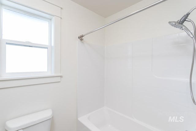 bathroom with shower / washtub combination and toilet