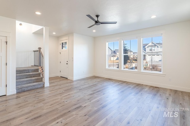 unfurnished living room featuring light hardwood / wood-style floors and ceiling fan