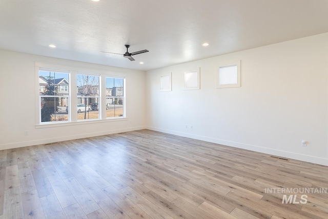 unfurnished room with ceiling fan and light wood-type flooring