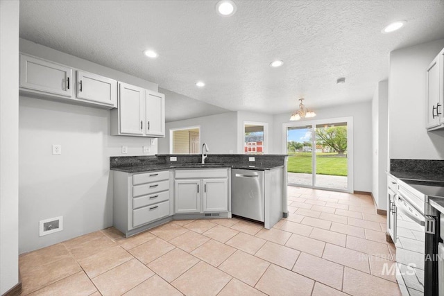 25022 Tumbleweed, Middleton, ID 83644 - kitchen with stainless steel dishwasher, a peninsula, a sink, electric range oven, and a chandelier