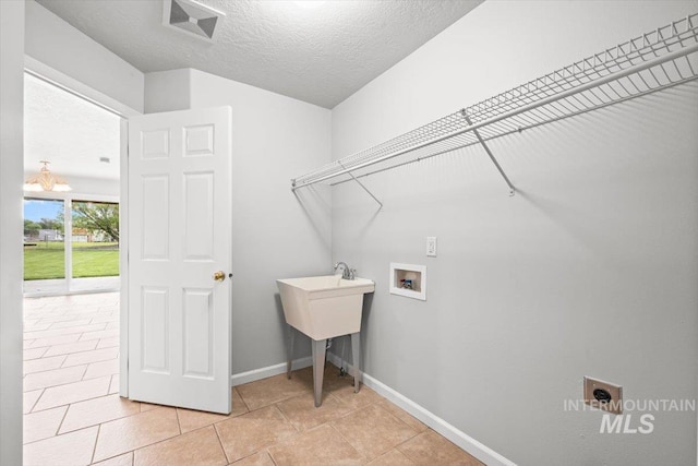 25022 Tumbleweed, Middleton, ID 83644 - washroom featuring washer hookup, baseboards, and a textured ceiling