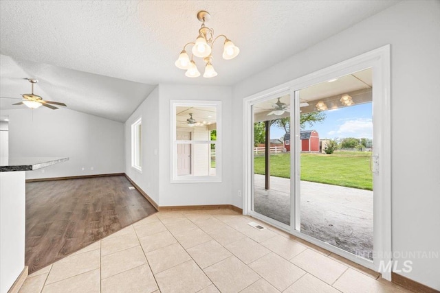 25022 Tumbleweed, Middleton, ID 83644 - entryway with ceiling fan, healthy amount of natural light, a chandelier, lofted ceiling, and a textured ceiling