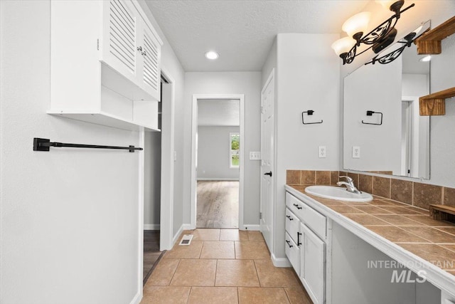 25022 Tumbleweed, Middleton, ID 83644 - bathroom featuring vanity, baseboards, recessed lighting, and a textured ceiling