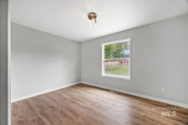 25022 Tumbleweed, Middleton, ID 83644 - unfurnished room with wood finished floors and baseboards