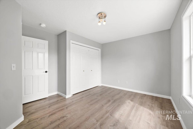 25022 Tumbleweed, Middleton, ID 83644 - unfurnished bedroom with baseboards, wood finished floors, and a closet