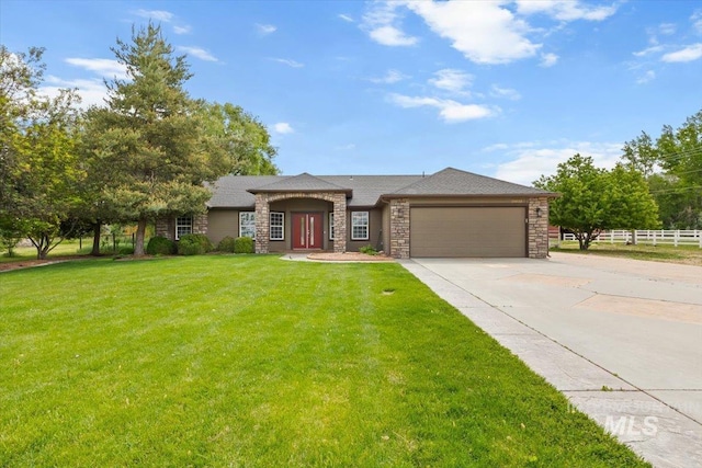 25022 Tumbleweed, Middleton, ID 83644 - view of front facade featuring a garage, driveway, and stone siding