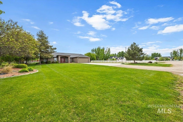 25022 Tumbleweed, Middleton, ID 83644 - view of grassy yard featuring concrete driveway and a garage
