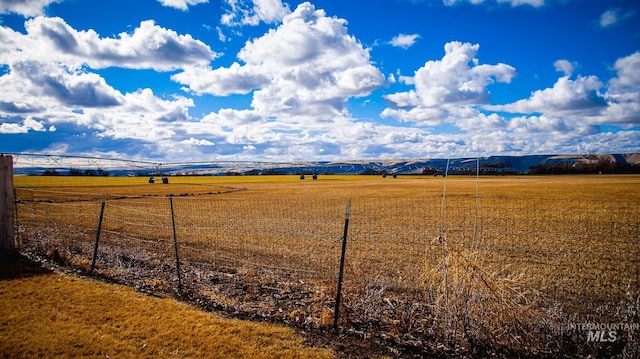 view of yard featuring a rural view and fence