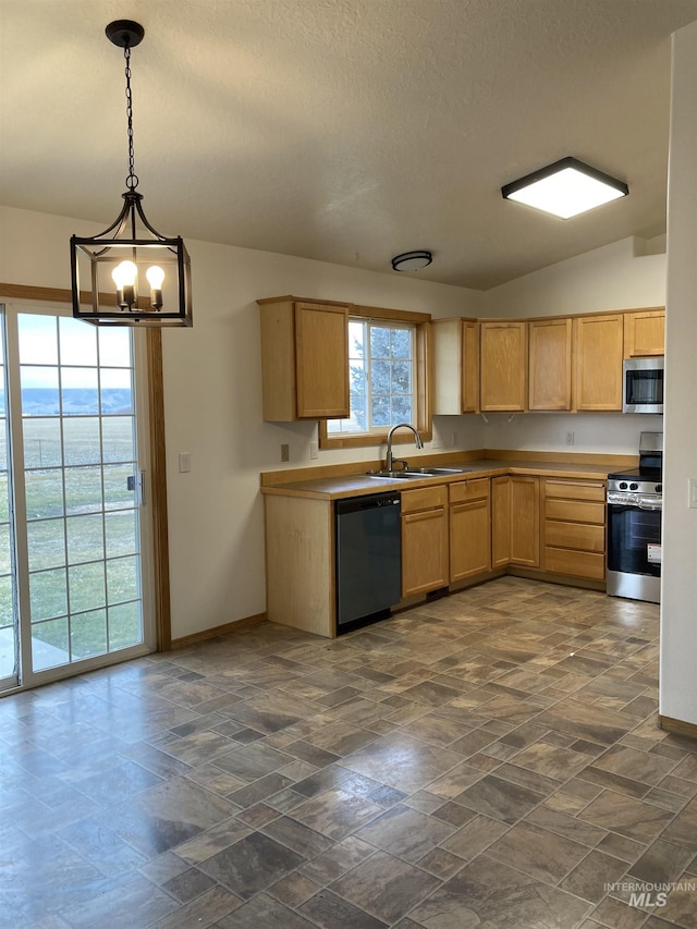 kitchen with vaulted ceiling, stainless steel appliances, a sink, and baseboards