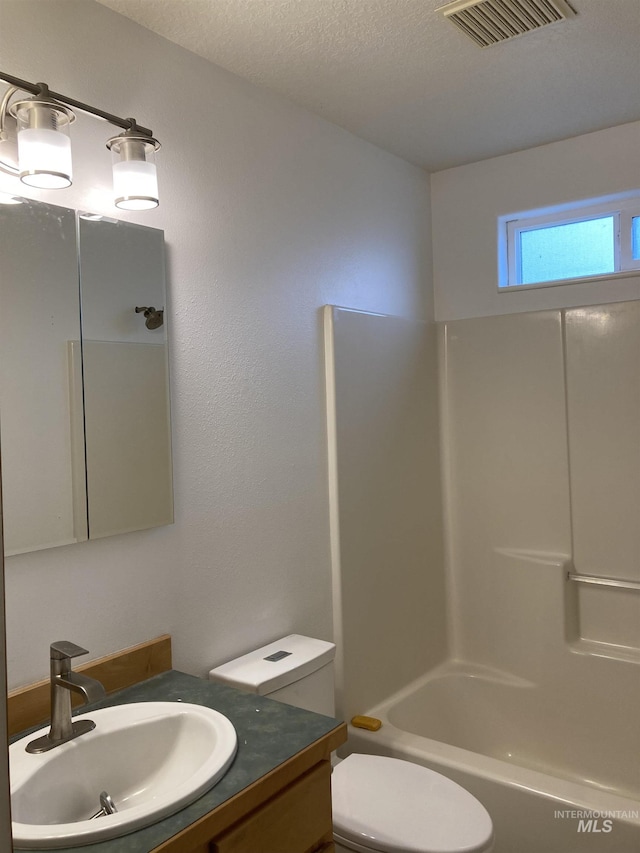 bathroom with visible vents, shower / bathing tub combination, toilet, a textured ceiling, and vanity