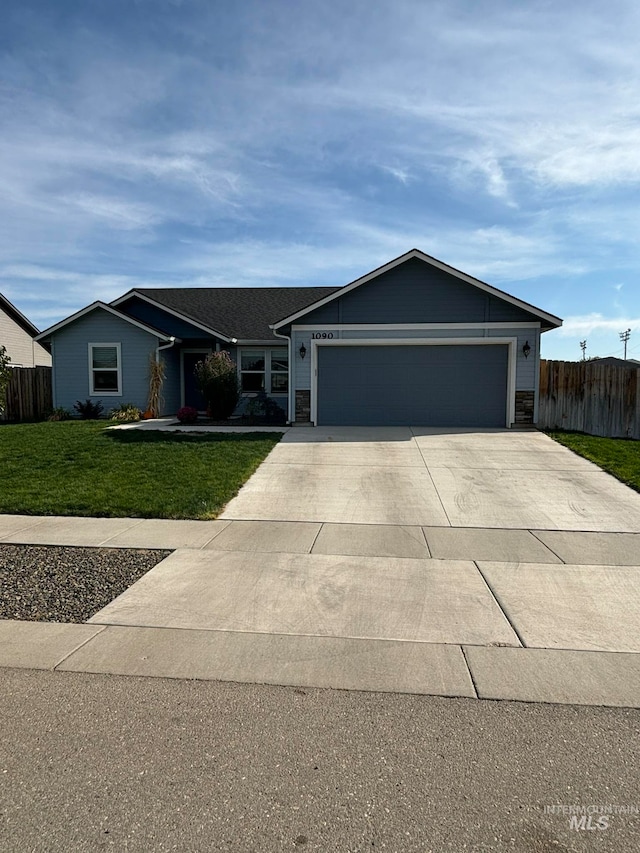 single story home with a front yard and a garage