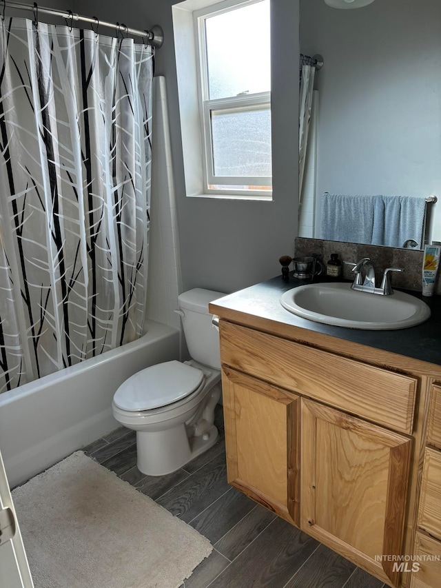 full bathroom featuring vanity, toilet, hardwood / wood-style flooring, and shower / bath combo with shower curtain